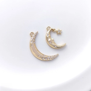Macro view of 14K gold plated crescent moon and moon face pendants with cubic zirconia