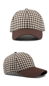 Detail of retro houndstooth pattern and brown brim on vintage baseball cap