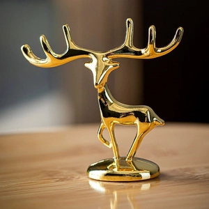 Detailed macro view of a polished golden deer jewelry holder with a reflective mirror finish