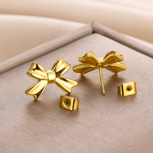 Macro shot of 18K gold plated stainless steel bow earrings on a jewelry tray