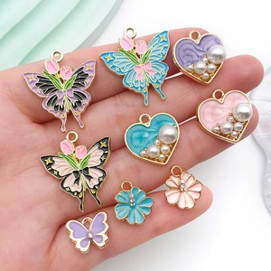 Assorted enamel butterfly and heart charms for DIY jewelry making with pearls and rhinestones