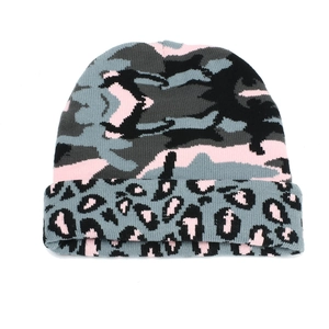 Macro detail of camouflage knit beanie featuring leopard print fold and soft texture