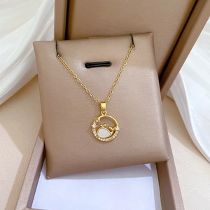 Detailed macro view of whale pendant in gold ring on premium leather jewelry box