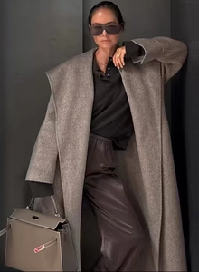 Detail of grey wool coat with large lapels and waist tie, elegant winter style for women