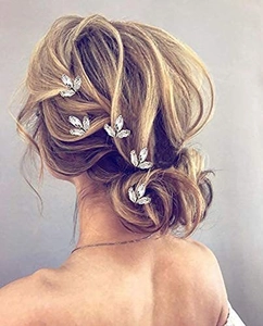 Detailed back view of silver leaf-shaped rhinestone hairpins styled in a bun