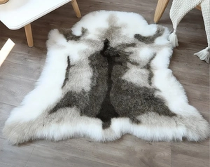 Close-up of faux reindeer fur rug texture showing soft plush fibers on wood floor