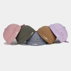 Close-up of small fish embroidery on various colored cotton docker hats for a stylish look