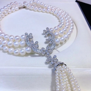 Three-layer pearl choker necklace with a silver flower diamond clasp and hanging tassels