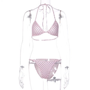 Detailed view of pink polka dot bikini set featuring halter top and matching bottoms