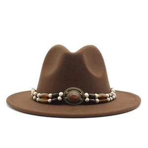 Detailed close-up of brown wool felt fedora featuring a vintage beaded hatband and gemstone