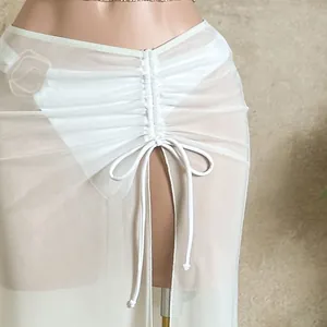 Detail of white mesh beach sarong featuring ruched drawstring waist and high slit design