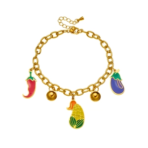 Charming gold-tone charm bracelet featuring colorful enamel vegetable pendants like pepper and corn
