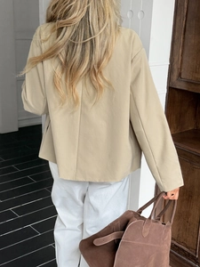 Back view of a casual beige long-sleeve blazer with a relaxed fit for women