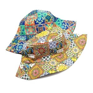Detailed flat lay of Bohemian sun hats featuring vibrant Sicilian tile patterns