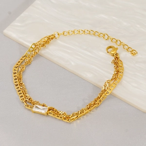 Detail of layered gold titanium steel bracelet with geometric links and crystal stone