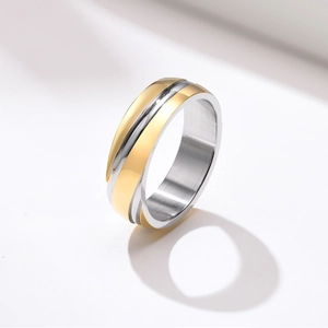 Detailed macro view of two-tone gold and silver stainless steel ring with black center groove