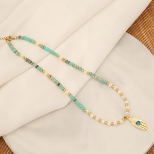 Detail view of Hamsa Hand pendant with turquoise bead on a colorful beaded necklace