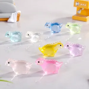 Close-up of mini resin dinosaur charms in candy colors for micro landscape decor