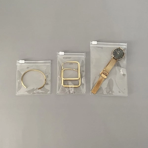 Three sizes of clear PVC jewelry storage bags with bracelets, earrings and watches inside