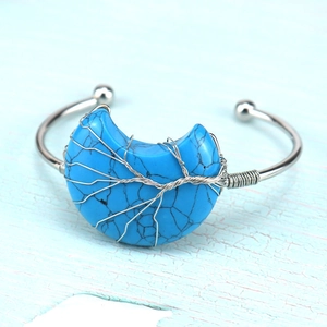 Detail of silver wire-wrapped tree of life on a crescent moon turquoise open bangle