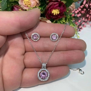 Detail of pink halo round zircon jewelry set including necklace and stud earrings