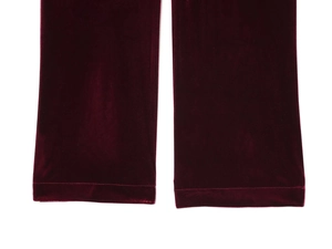 Detail view of deep red velvet fabric texture with soft sheen and refined stitching