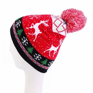 Detailed knit of Christmas beanie featuring white reindeer patterns and festive pom-pom