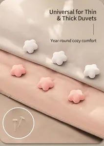 Star-shaped quilt clips in pink and white for all-season comforter fastening