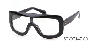 Close-up of gold triple rivet hinge detail on black oversized aviator sunglasses