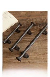 Close-up of vintage cast iron handle with matte texture on a wooden desk with a book