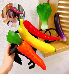 Detailed close-up of funny 3D vegetable headbands featuring pepper and eggplant