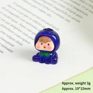 Macro shot of a mini resin cartoon figure in blue hoodie on an open book, size 19x15mm