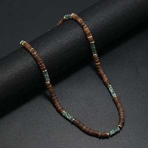 Detail of bohemian necklace with brown coconut beads and green natural stones