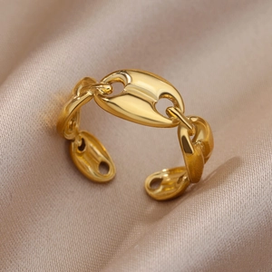Macro detail of gold-plated stainless steel coffee bean style open ring on satin