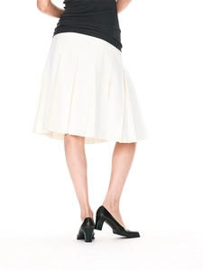 Detail of a white pleated knee-length skirt showing crisp pleats and high-quality fabric texture