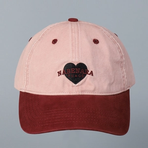 Close-up of heart embroidery on washed cotton color-block baseball cap with detail stitching