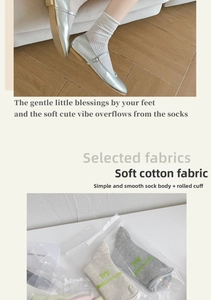 Detail of soft cotton crew socks with rolled cuff design in minimalist packaging