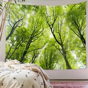 Detail of forest tapestry hanging over bed showing lush green canopy wall decor