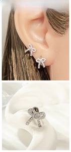 Detail showing bow knot earrings with silver plating and cubic zirconia on a model