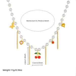 Pastel pearl necklace with cherry, butterfly and heart charms plus gold chain tassels