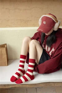 Detail of red and white striped knit cashmere socks with ribbed cuff and warm texture