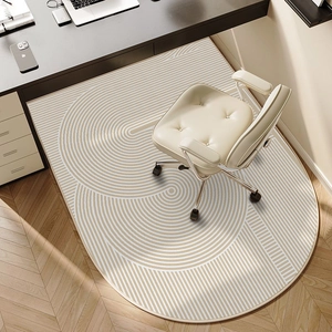 Oval TPR computer chair mat with geometric pattern on wooden floor under a desk chair