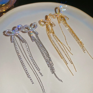 Elegant bow tassel drop earrings with sparkling crystals in gold and silver finish