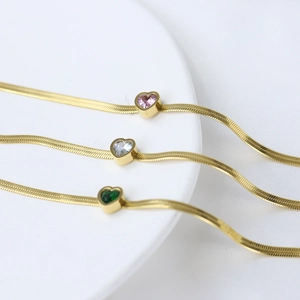 Detail of 14K gold stainless steel snake chains with pink, white and green heart stones