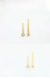 Detail of golden brushed metal clock hands with mounting holes for DIY quartz movement