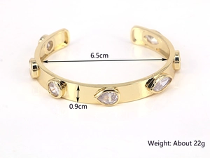 Gold plated open cuff bracelet featuring teardrop and round white zircon gemstones