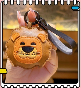 Detailed view of a brown and orange lion-shaped leather keychain with black strap