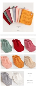 Detail of 100% cotton muslin burp cloths featuring soft bubble texture and hanging loops