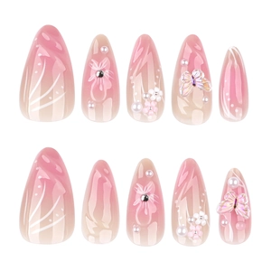 Short almond press-on nails with 3D floral accents, pearls, and pink gradient design
