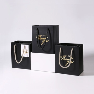 Elegant black gift bags with gold 'Thank you' foil stamping and braided rope handles